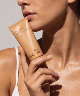 Hand Cream tube held against the shoulder
