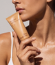 Hand Cream tube held against the shoulder