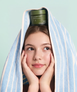 Model using Oat Milk Balm Cleanser